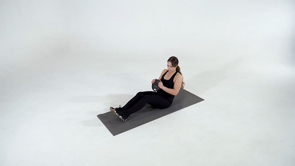 Female doing workouts on exercising machine.